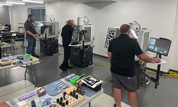 Teachers being trained in the metal milling class from NC3