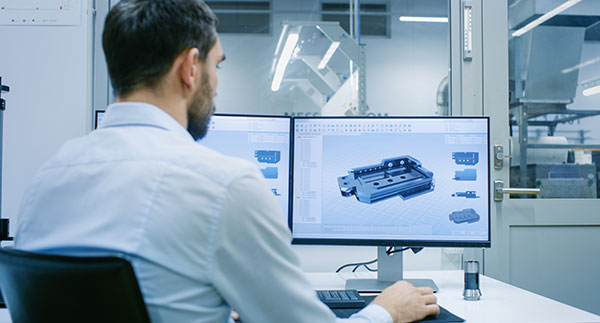 Machine operator using  CAM software to turn the CAD drawing into tool paths