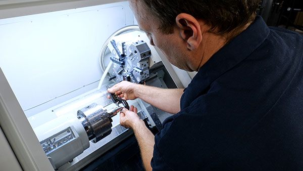 machine tech operating the 15LX CNC Lathe